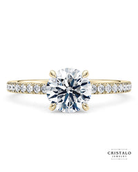 The Aria diamond band engagement ring with an oval-cut diamond in 18k yellow gold. Features a 1.70mm band with a Castle setting.