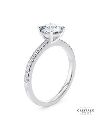 Diamond band engagement ring with a Castle setting in 18k white gold. The ring features 4 claws and is WedFit.