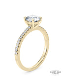An elegant Aria ring, combining a classic solitaire with a diamond band to create a balance of brilliance and understated beauty