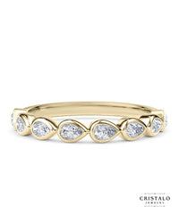 The Idyll ring with a row of pear-shaped diamonds in an 18k yellow gold Bezel setting. A designer set piece with a total diamond weight of approx. 0.35ct.