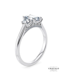 A vintage-inspired Imperia Trilogy ring, showcasing the elegant display of rippled light from its step-cut emerald diamonds.