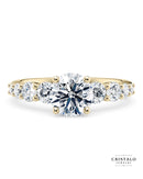 The Lyra diamond band engagement ring with a graduated Princess cut diamond in 18k yellow gold. This ring features a 2.00mm band with a total weight of approx. 0.70ct.