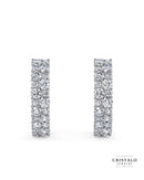 The Orion diamond hoop earrings in 18k white gold. This piece features a cluster of alternating diamonds in a Claw setting, with a total weight of approx. 0.80ct.