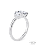 A perfect symbol of unity: The Toi et Moi ring, showcasing a pear and a round diamond linked in a tender embrace on a white gold band.